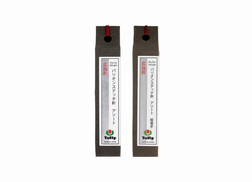 Two identical black and gray boxes with red labels, each containing Japanese text and a logo.