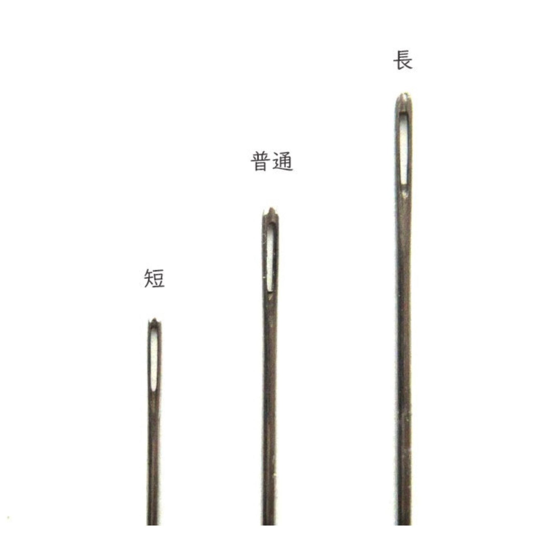 three different sizes of sewing needles, each with a distinct hole size, arranged in a row.