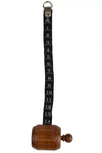 A wooden object with a metal hook attached to it, displaying a series of numbers on a black strap.