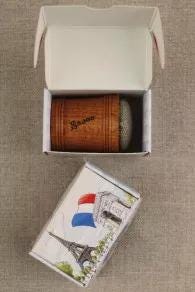 a wooden box with a French flag design, and a white box with a picture of the Eiffel Tower on it.
