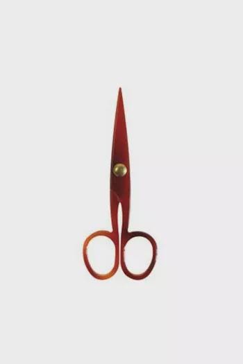 A pair of red scissors with gold-colored tips and handles.