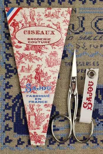 a pair of scissors and a package of fabric scissors, both with the brand name "SAJOU" printed on them.