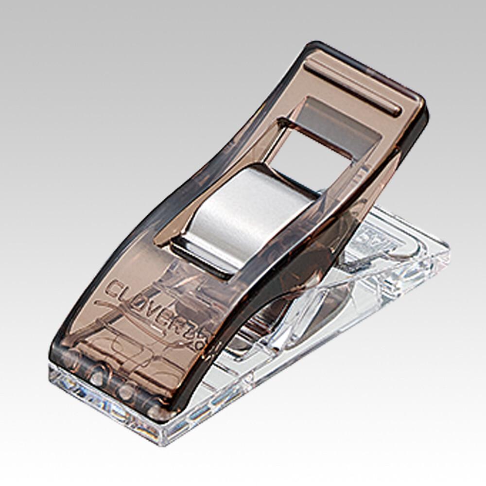 a brown and clear plastic clip with a silver metal piece.