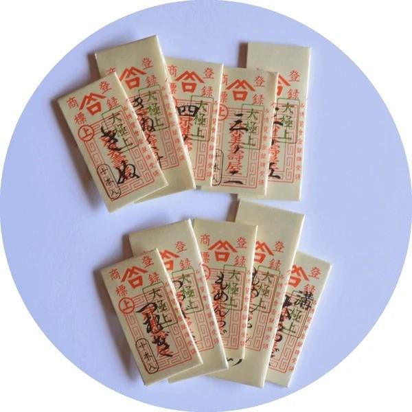 a circular arrangement of white rectangular cards with red and black text and symbols, likely representing tickets or passes.