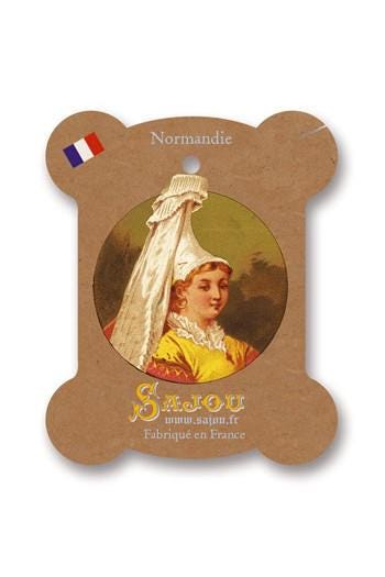 a woman wearing a yellow dress and a white headdress, with a French flag on the left side.