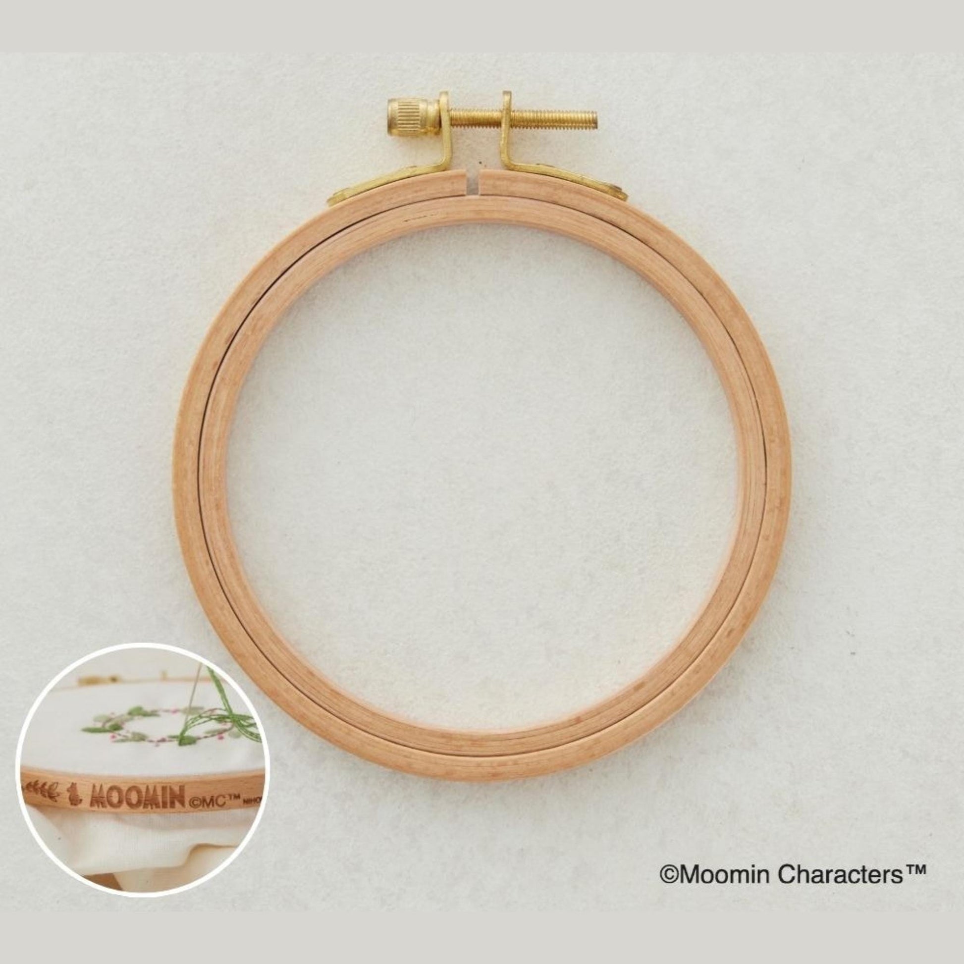A wooden embroidery hoop with a gold-colored metal bracket, and a close-up image of the bracket and the hoop.