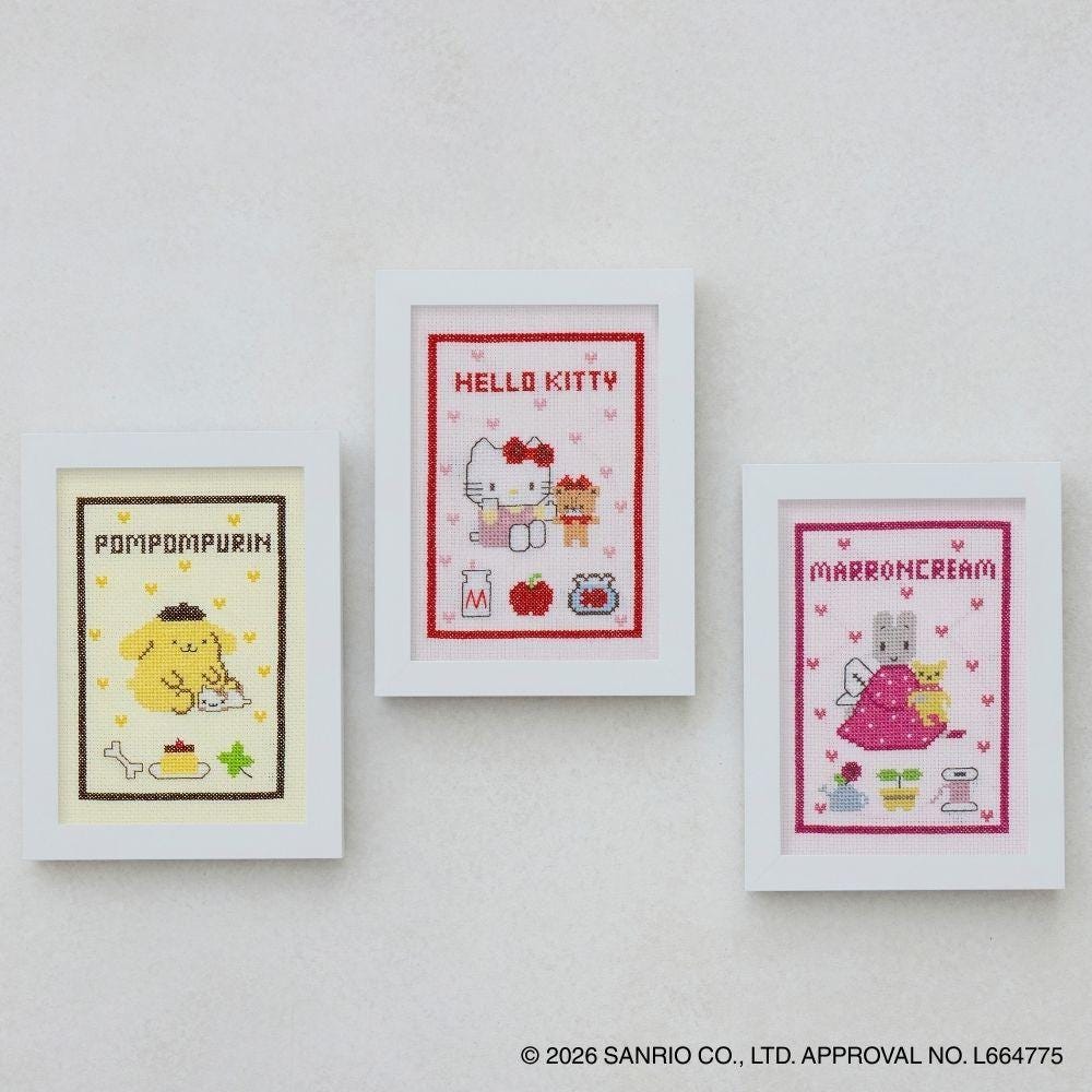 three framed cross-stitch designs featuring characters from the Hello Kitty franchise.