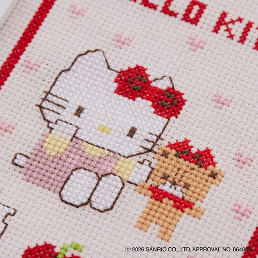 The image is a close-up of a cross-stitch pattern featuring two characters, a Hello Kitty and a teddy bear, with the text "Hello Kitty" written above them.
