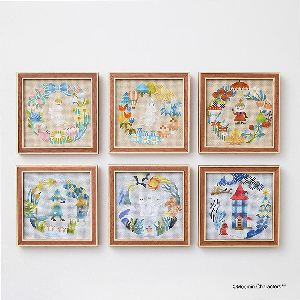 a collection of six framed cross-stitch artworks, each featuring a unique design and color scheme. The artworks are arranged in a grid pattern on a white wall, showcasing the creativity and skill of the artists.