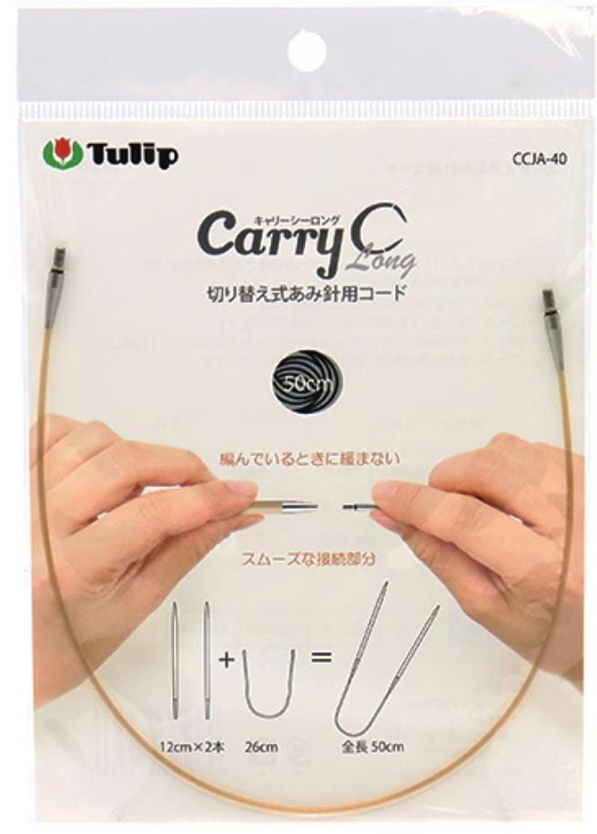 a pair of hands holding a knitting needle with a clear packaging that includes text and diagrams.
