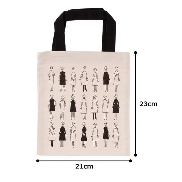 The image is a tote bag with a printed design of stylized human figures in black and white.