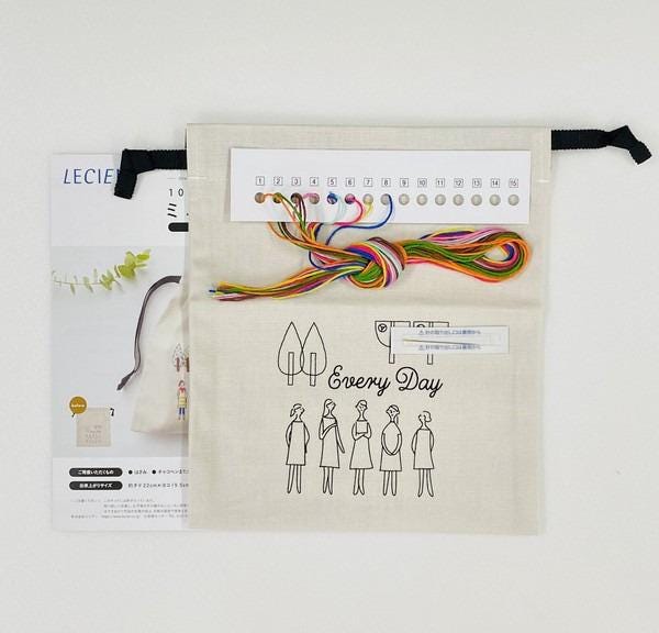 a sewing kit with various sewing supplies and a booklet with instructions.