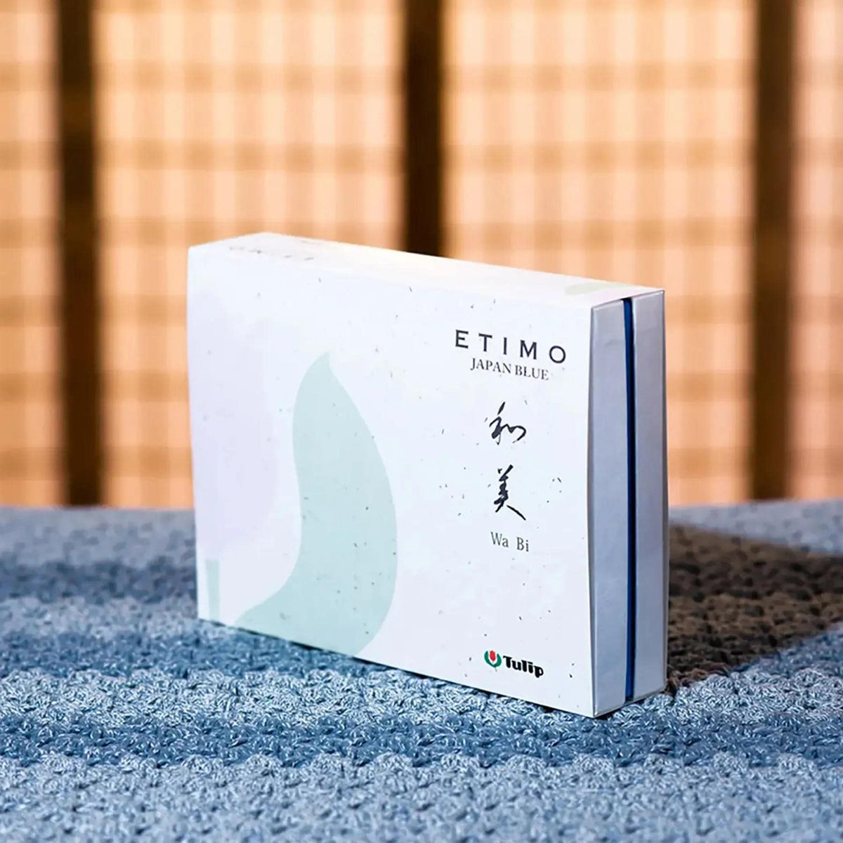 A white box with text and a logo, placed on a blue surface.