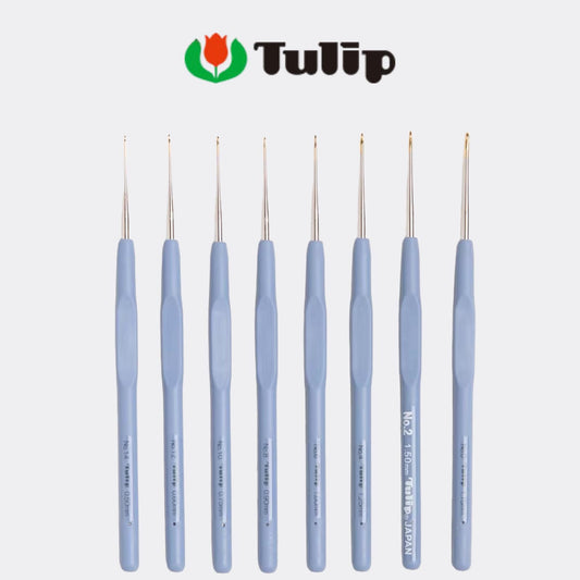 A collection of nine crochet hooks in various sizes and colors, arranged in a row against a white background.