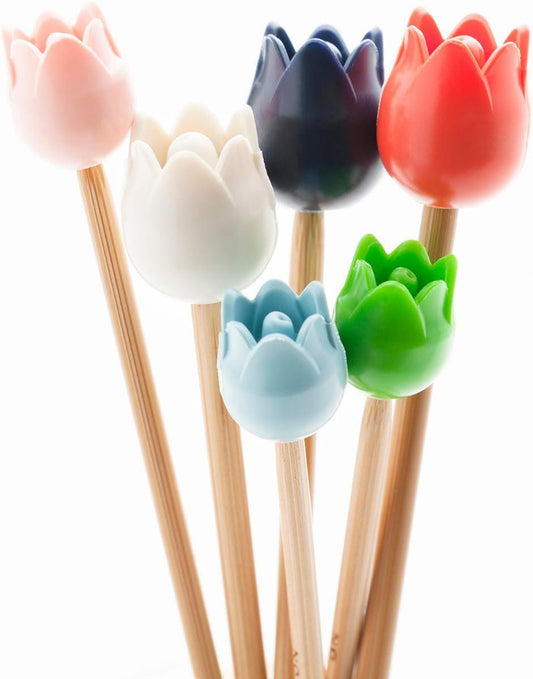 A group of colorful flower-shaped pencil holders, each with a different color and design, arranged together.