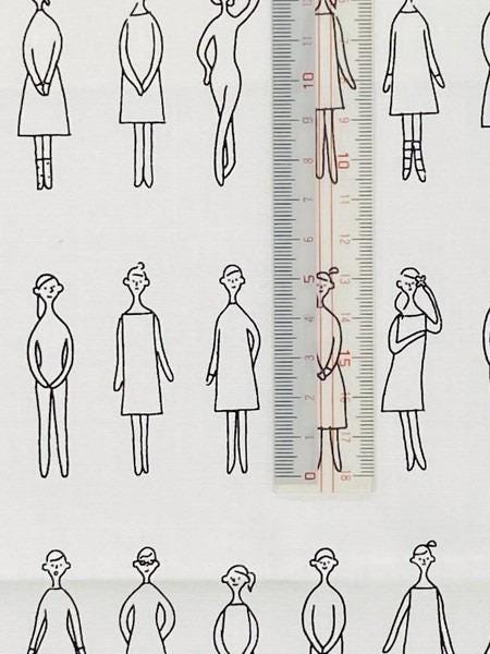 a collection of simple line drawings of people, with a ruler placed in the center to indicate the size of the drawings.
