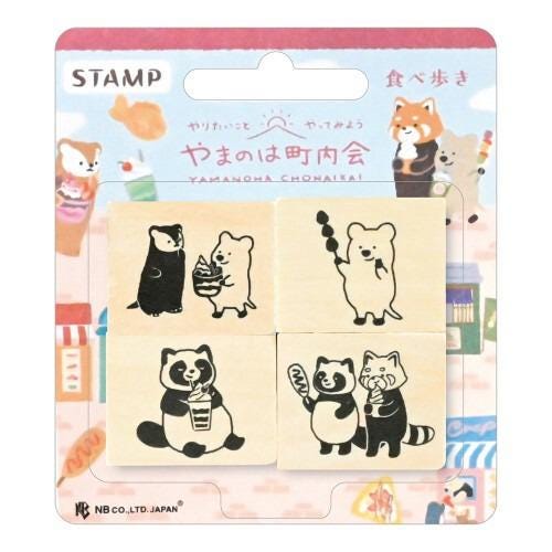 The image is a package of four wooden stamps featuring various cartoon animal characters, including a bear, a raccoon, and a penguin.