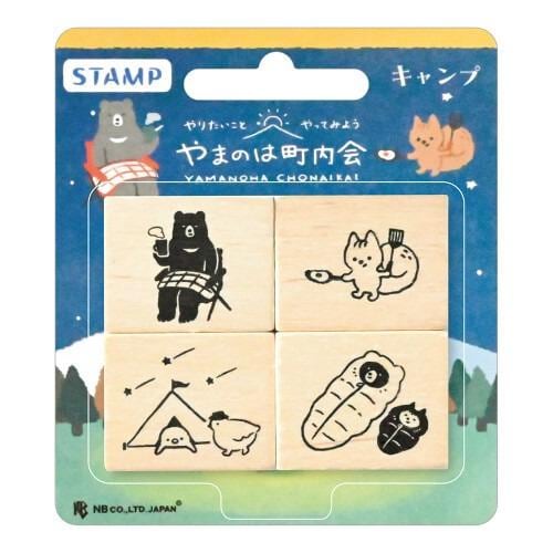 The image is a stamp package containing four wooden blocks with various animal illustrations and camping scenes.