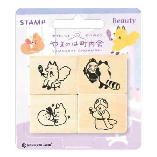 The image is a stamp package containing four wooden blocks with various animal illustrations, including a fox, raccoon, cat, and dog.
