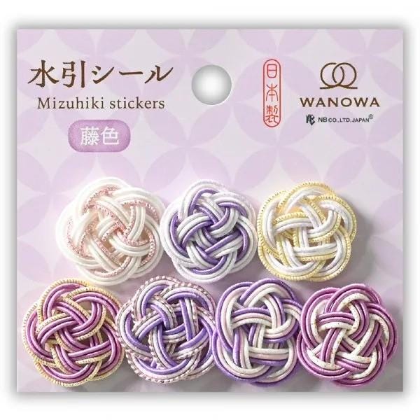 The image is a product packaging for Mizuhiki stickers, featuring a variety of colorful braided designs in shades of purple, white, and gold.