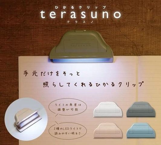 The image is an advertisement for a product called "terasuno". It features a close-up of a stapler with a light on top of it, and there are various colored staplers displayed below. The text in the image is in Japanese and includes descriptions of the product, such as "The stapler is a lighted stapler" and "The stapler is a lighted stapler".