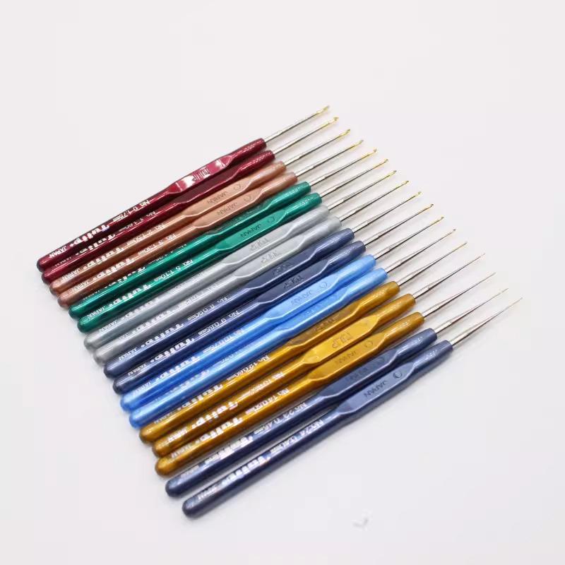 A collection of colorful crochet hooks arranged in a grid-like pattern on a white background.