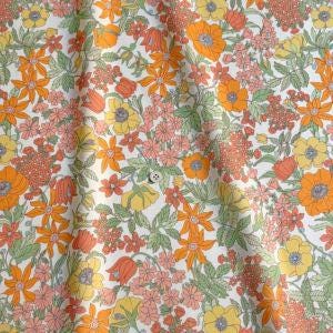 a vibrant floral pattern with a variety of orange, yellow, and pink flowers and leaves.