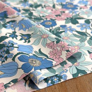 a close-up view of a fabric with a floral pattern in shades of blue, pink, and green.