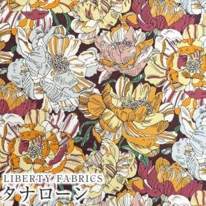 The image is a vibrant and colorful floral pattern featuring various shades of orange, yellow, and pink flowers against a dark background.