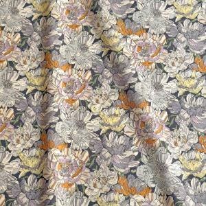 a repeating pattern of various colored flowers, including white, yellow, and orange, against a dark background.