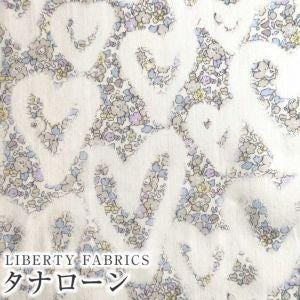 The image is a close-up of a fabric with a floral pattern, featuring various shades of gray and white. The fabric appears to be made of a soft, delicate material.
