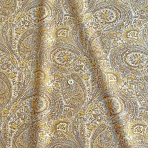 a close-up view of a fabric with a repeating paisley pattern in shades of yellow, white, and gray. The fabric appears to be made of cotton and has a crinkled texture, giving it a soft and delicate appearance.