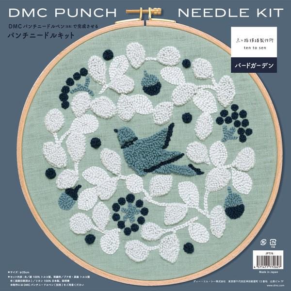 The image is a detailed embroidery pattern featuring a bird and various flowers and leaves in shades of blue and white.