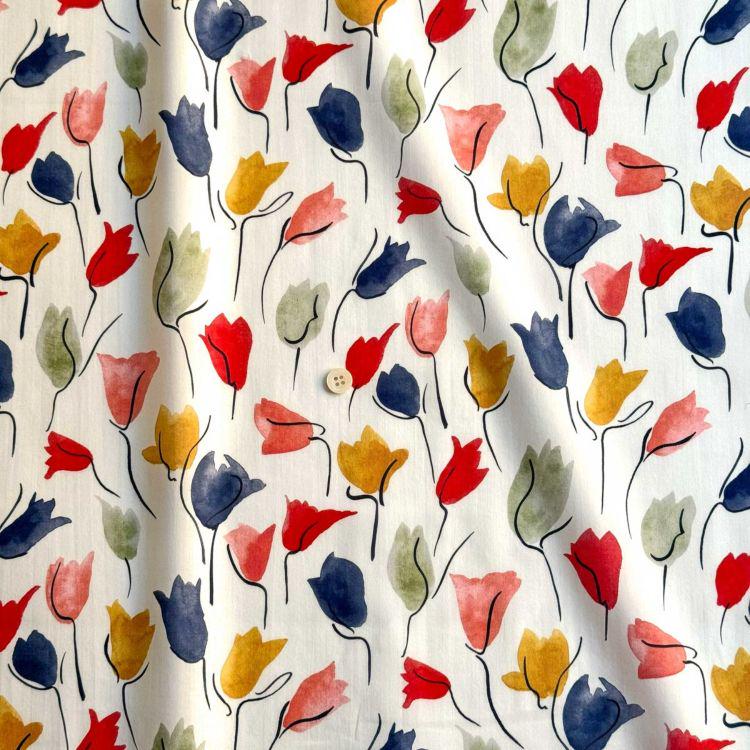 a repeating pattern of colorful flowers on a white background.