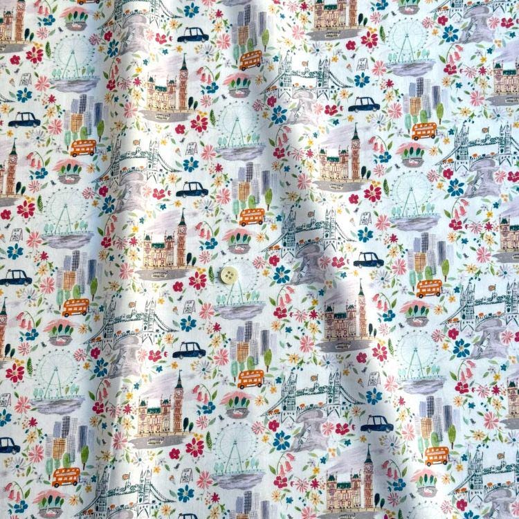 The image is a collage of various colorful illustrations of landmarks and cityscapes, including buildings, bridges, and vehicles, all set against a white background.
