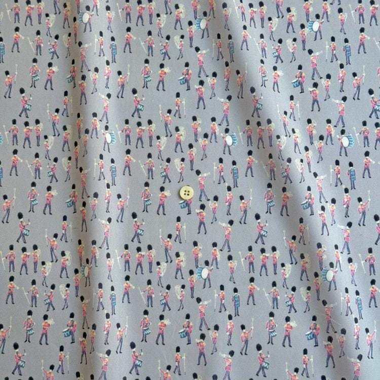 a repeating pattern of soldiers marching in formation, with a single button visible in the center of the pattern.
