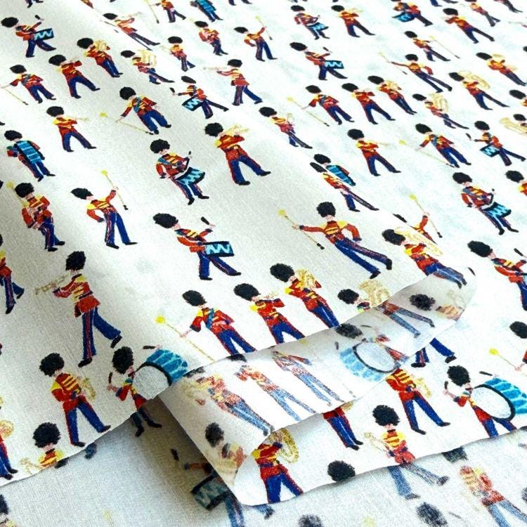 The image is a collage of various printed patterns featuring people playing musical instruments, such as drums and guitars.