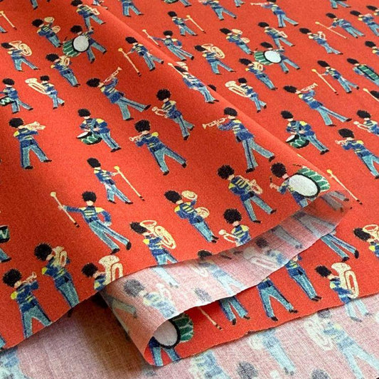 a repeating pattern of people playing musical instruments, such as drums and brass instruments, on a red background.