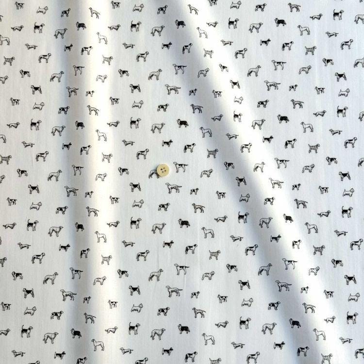 a repeating pattern of black and white dog silhouettes on a white background.