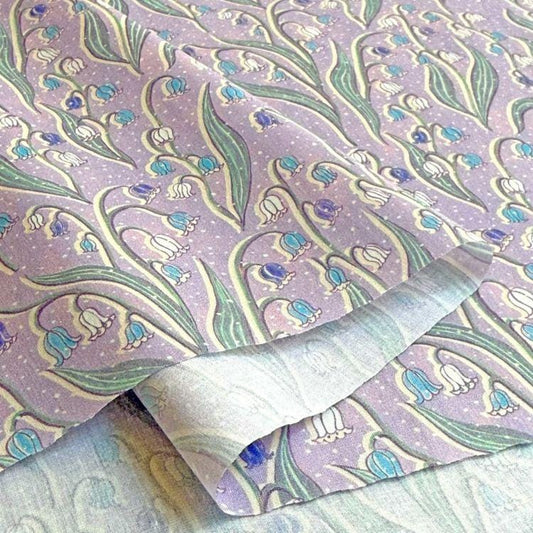 a fabric with a repeating pattern of blue and white flowers, creating a visually appealing and intricate design.