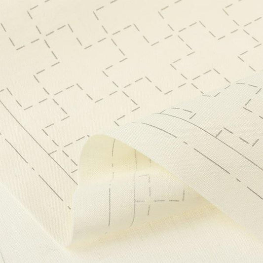 a close-up view of a piece of fabric with a repeating pattern of black lines and dots, creating a geometric design.