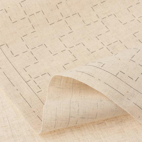 a close-up view of a piece of fabric with a repeating pattern of squares and lines, creating a textured and geometric design.