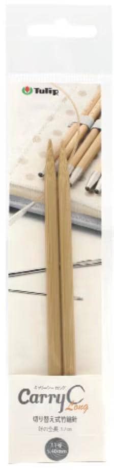 a pair of wooden knitting needles, with a focus on the needles and a blurred background that includes other knitting tools and materials.