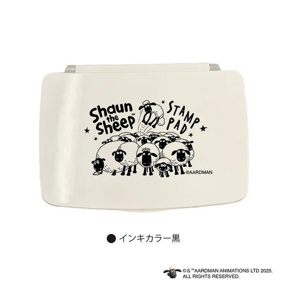 A white object with a black and white illustration of a group of sheep and the text "Shaun the Sheep" printed on it.