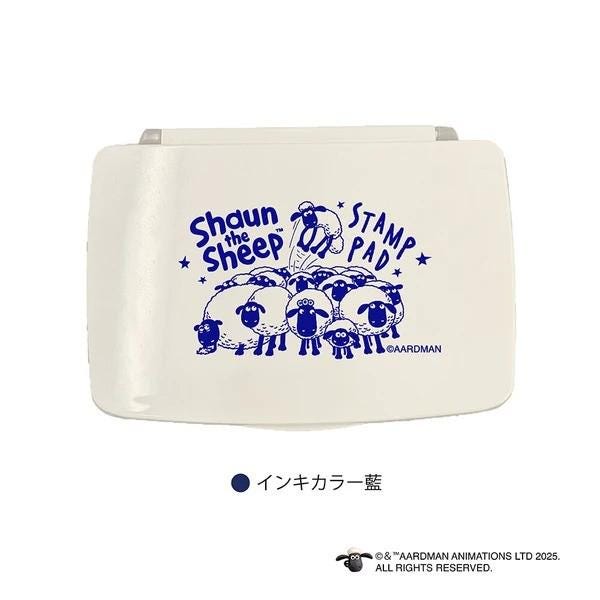 a white rectangular object with a blue design on it, depicting a group of sheep.