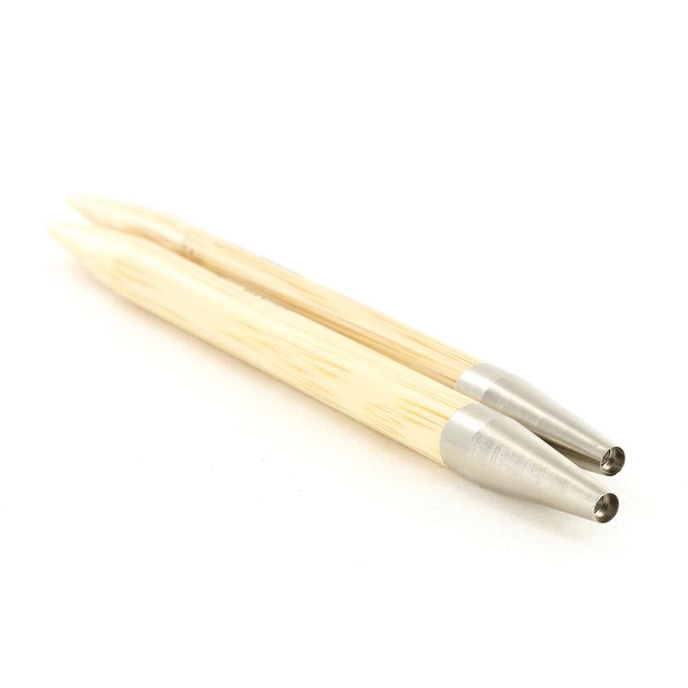 A pair of wooden knitting needles with silver tips are shown against a white background.