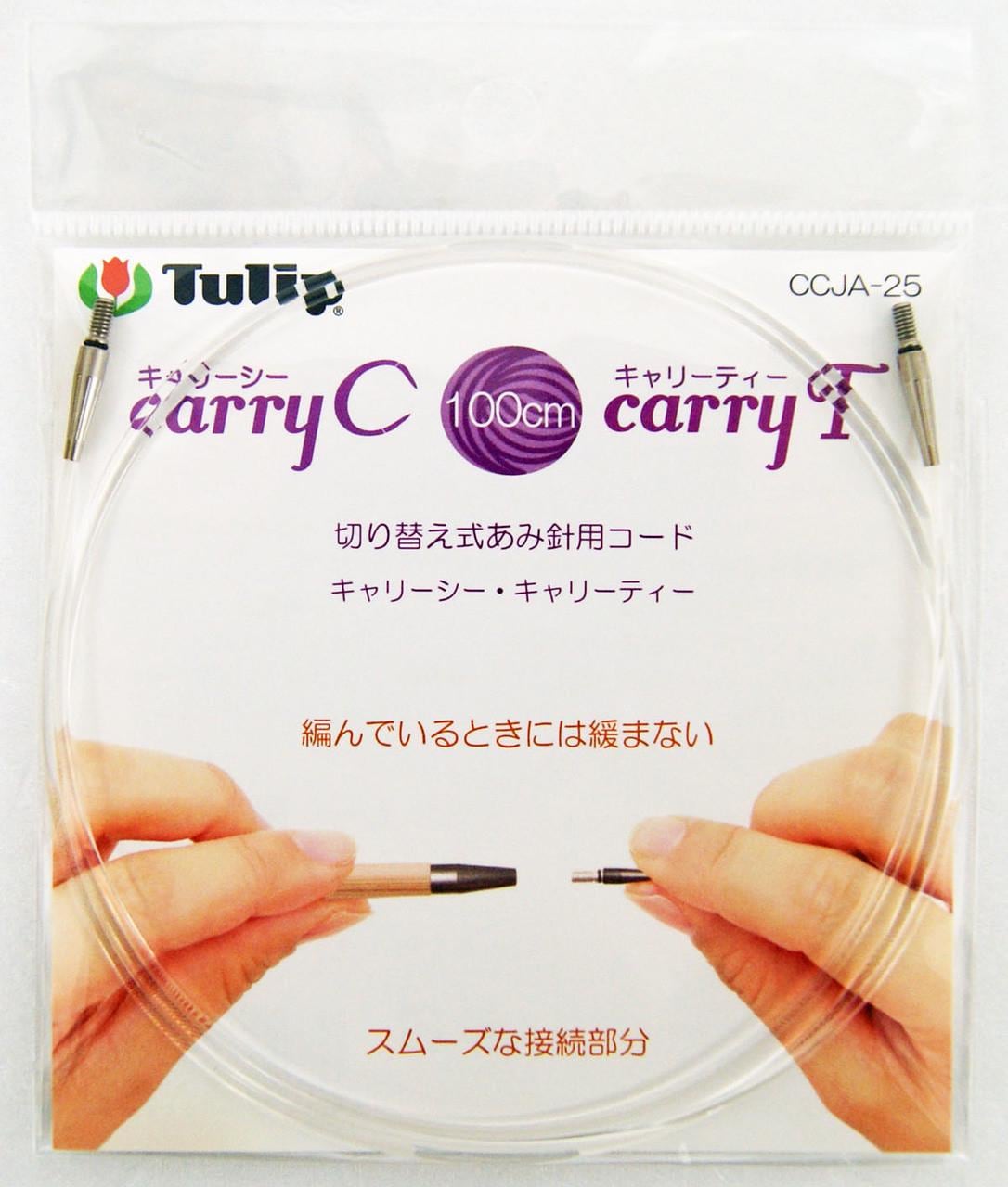 a pair of hands holding a clear plastic bag with a purple and white label that reads "100cm carry-all".