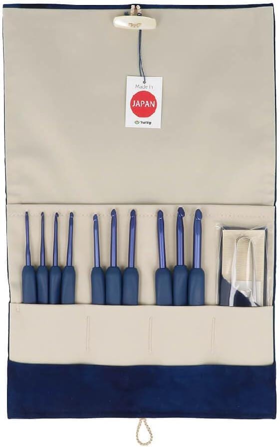 A set of blue crochet hooks is displayed in a beige and blue pouch, with a tag indicating they are made in Japan.