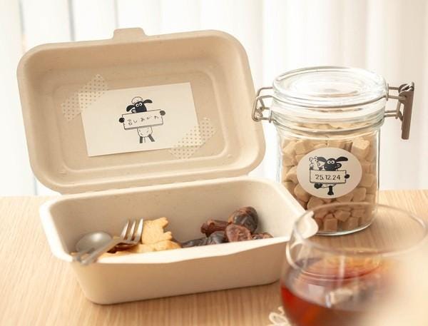 a meal consisting of a takeout container with a spoon and fork, a glass of wine, and a jar of sugar cubes.