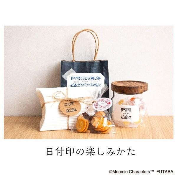 a variety of snacks and a gift bag, all placed on a wooden surface.